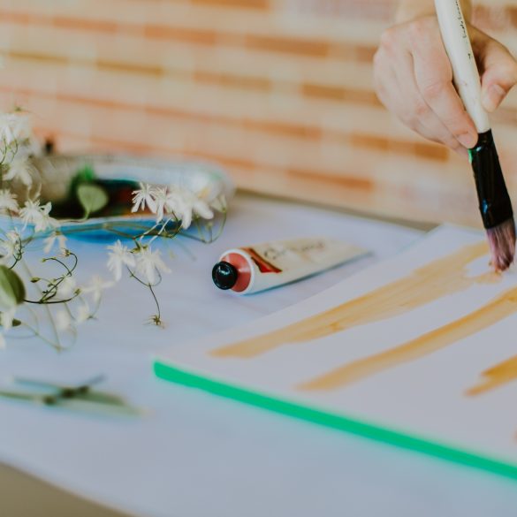 Freelance textile designer at a desk painting and creating stripes for a repeating design